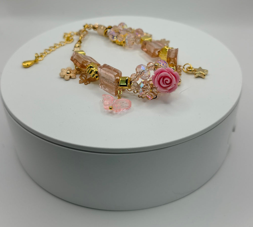 Decorative bracelet on a white circular stand against a light gray background