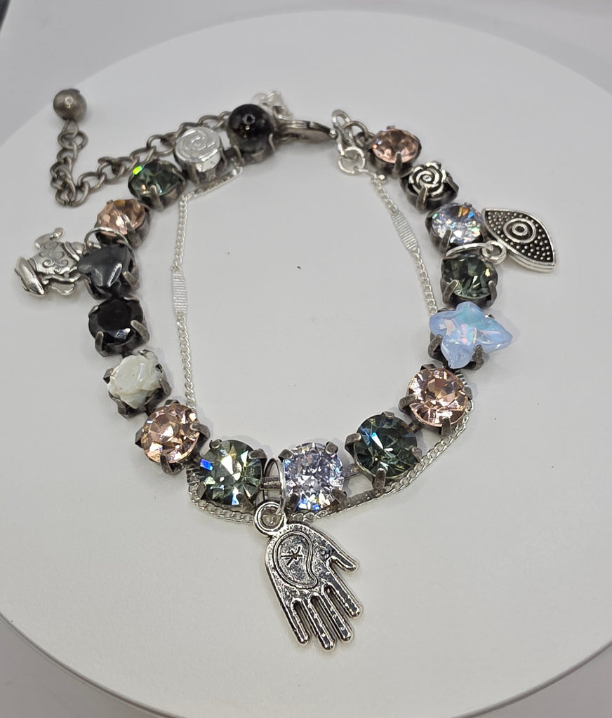 Bracelet with various charms on a white background